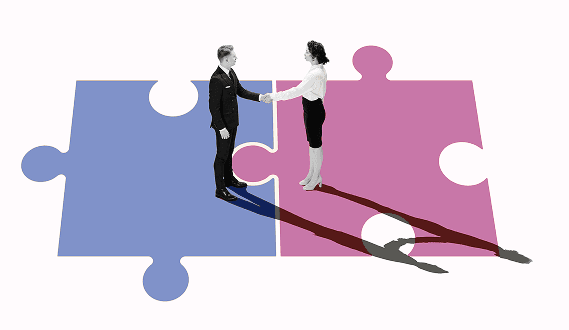 A man and a woman shaking hands in agreement of signing up for the Power Values corporate training program.